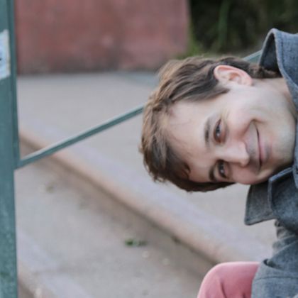 Aaron Gervais sitting on steps in Golden Gate Park
