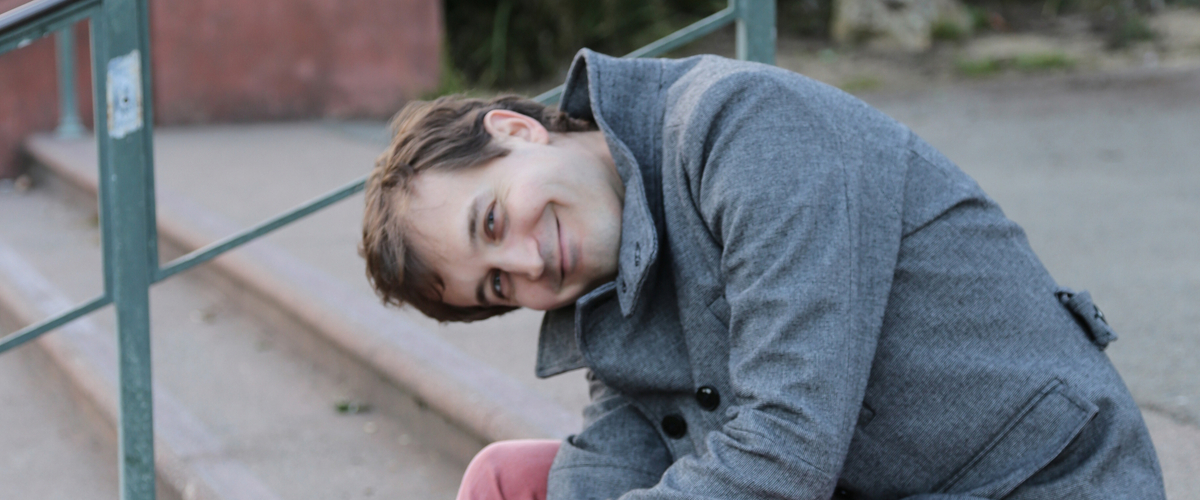 Aaron Gervais sitting on steps at Golden Gate Park