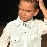 boy scratching his head